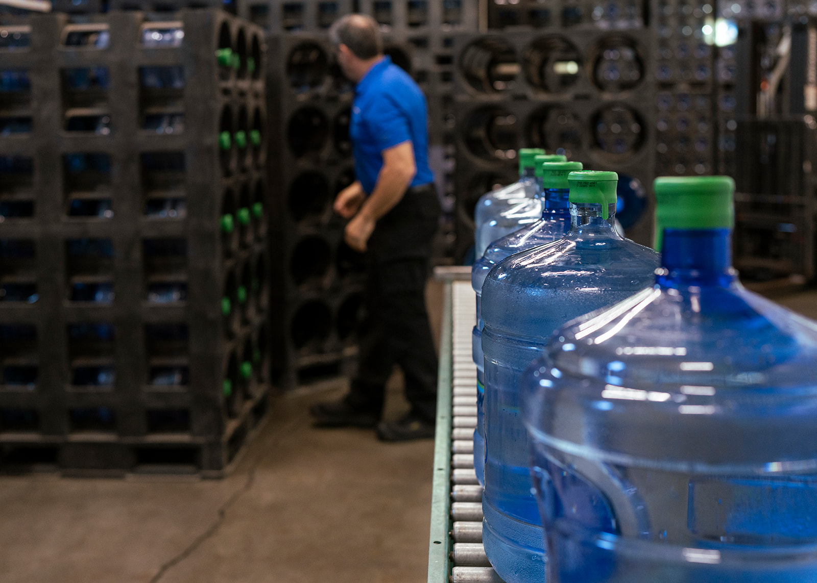 Right-side view of five water dispenser bottles lined up vertically