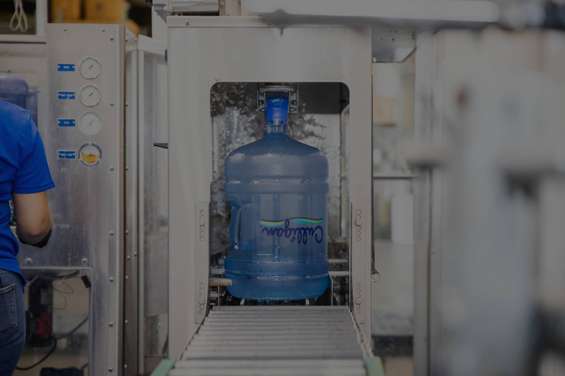 A Water dispenser bottle by Culligan being refilled by a machine
