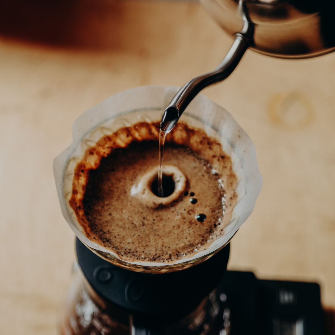 Pouring water into a coffee filter.